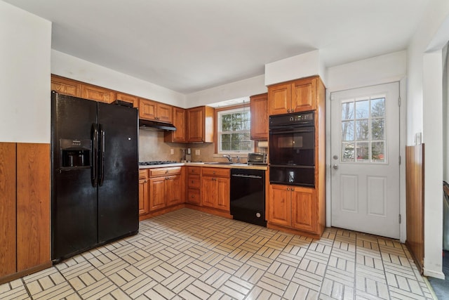 kitchen with black appliances and tasteful backsplash