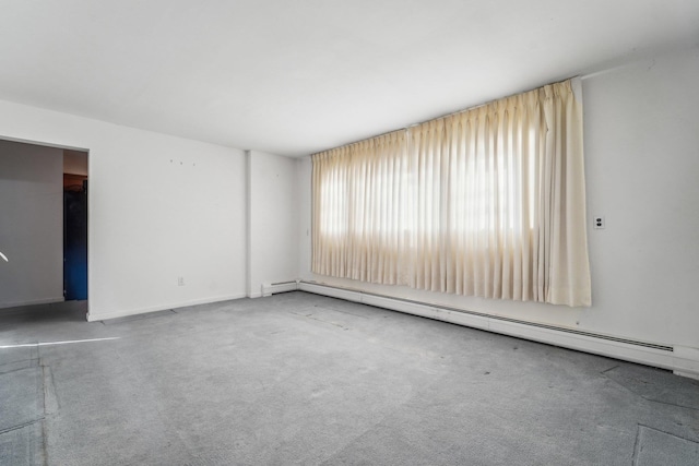 carpeted spare room with baseboard heating