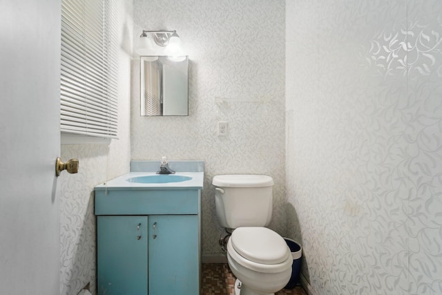 bathroom with toilet and vanity