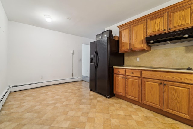 kitchen with a baseboard heating unit, tasteful backsplash, and black appliances