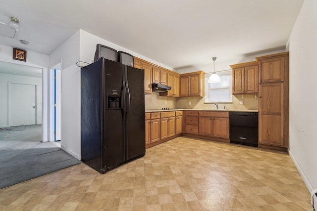 kitchen featuring a baseboard heating unit, black appliances, and pendant lighting