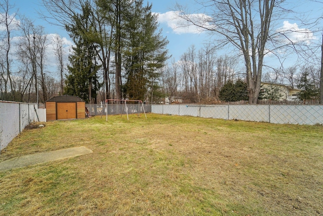 view of yard with a playground and a storage shed