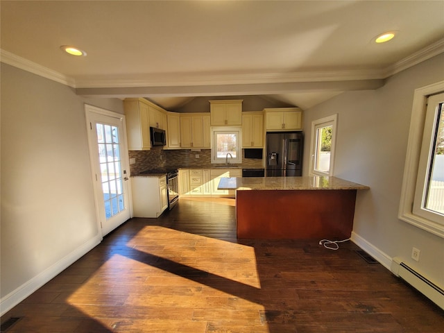 kitchen with a baseboard radiator, appliances with stainless steel finishes, tasteful backsplash, sink, and stone countertops