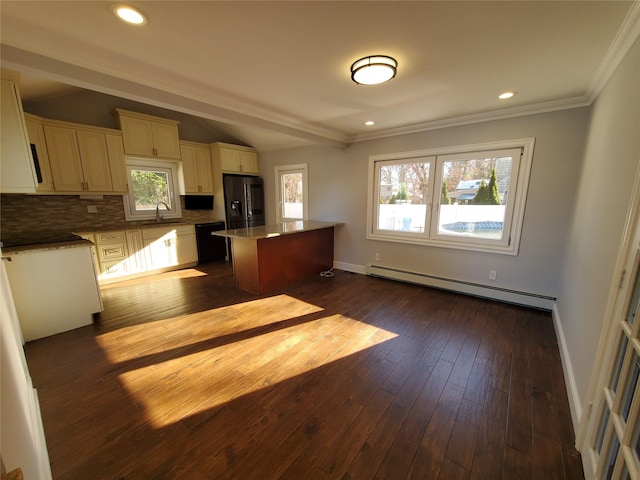 kitchen with stainless steel fridge with ice dispenser, backsplash, a baseboard radiator, a kitchen island, and sink