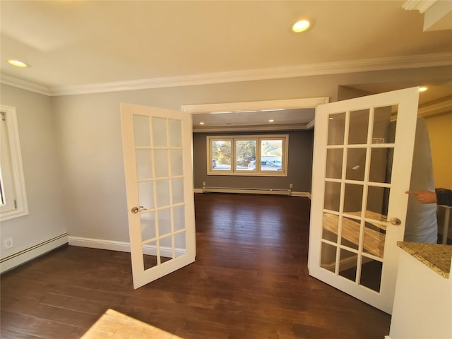 empty room featuring a baseboard heating unit, dark wood-type flooring, crown molding, and french doors