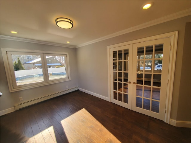 empty room with a baseboard heating unit, dark hardwood / wood-style flooring, french doors, and crown molding