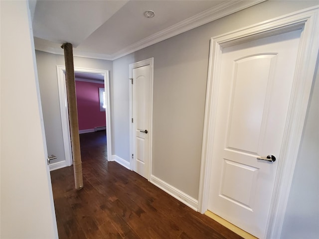 hallway featuring dark wood-type flooring, ornamental molding, and a baseboard radiator