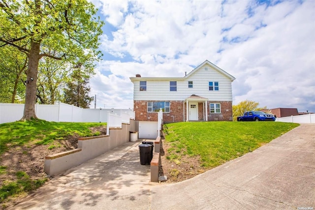 front of property featuring a front yard and a garage