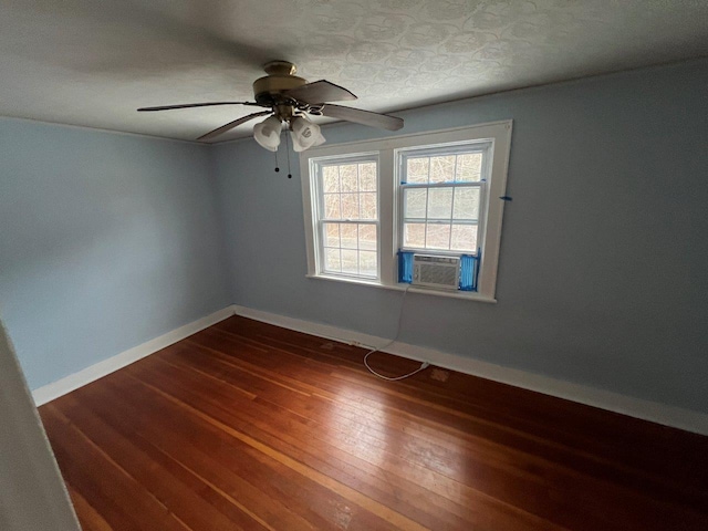 empty room with ceiling fan, cooling unit, and dark hardwood / wood-style floors