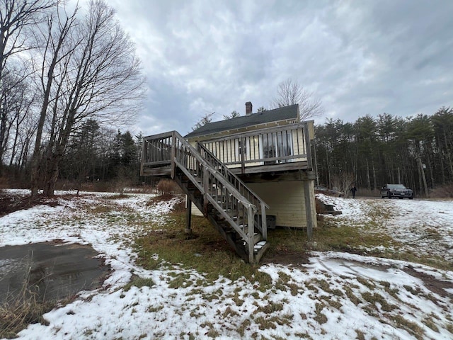 view of snowy exterior featuring a wooden deck