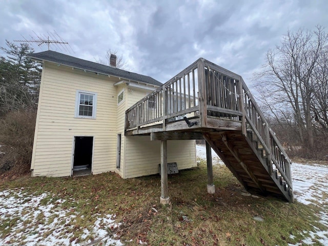 snow covered property with a deck