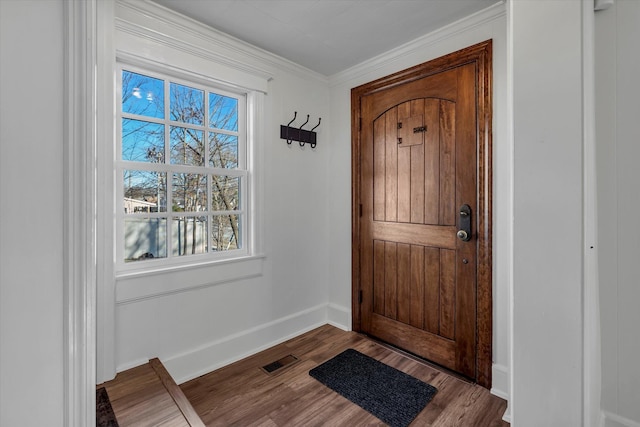 entryway with crown molding and hardwood / wood-style floors