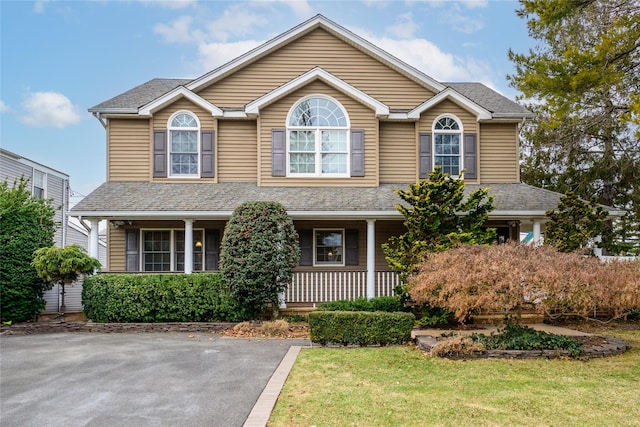 front facade with a front yard and a porch