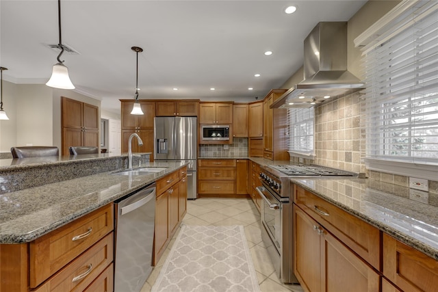 kitchen with stainless steel appliances, decorative light fixtures, island range hood, and light stone countertops