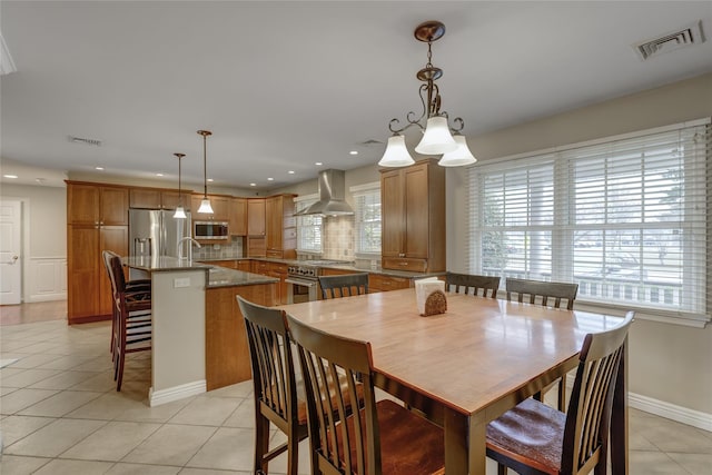 dining space with sink and light tile patterned floors