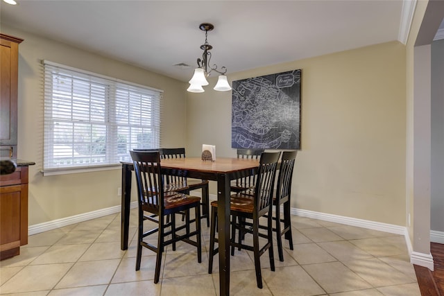 tiled dining space with a notable chandelier