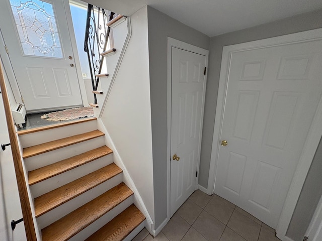 stairway with tile patterned floors