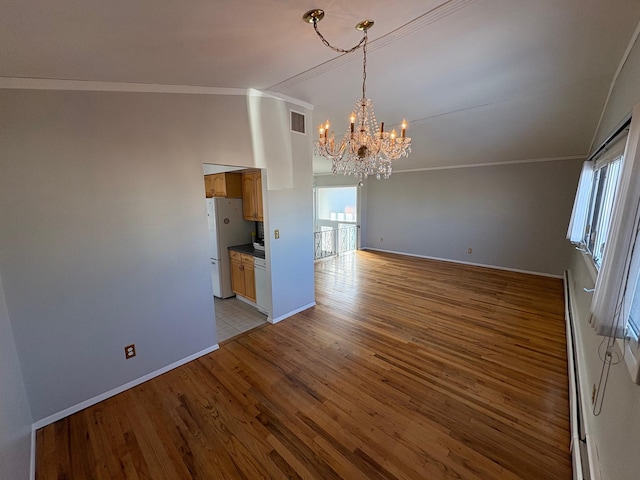 unfurnished dining area with light hardwood / wood-style flooring, crown molding, a baseboard radiator, and a chandelier