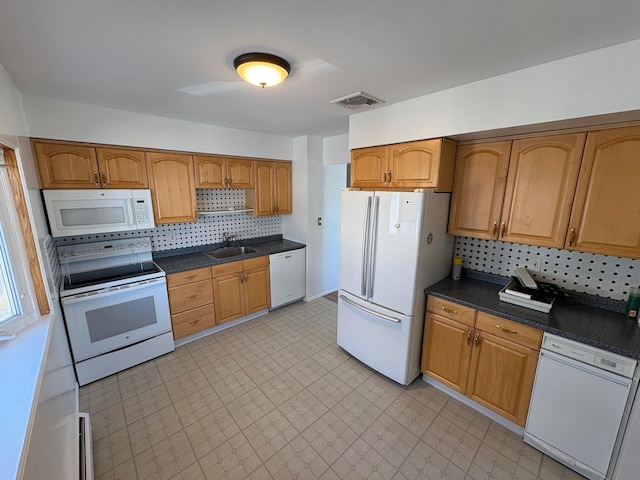 kitchen with backsplash, white appliances, and sink