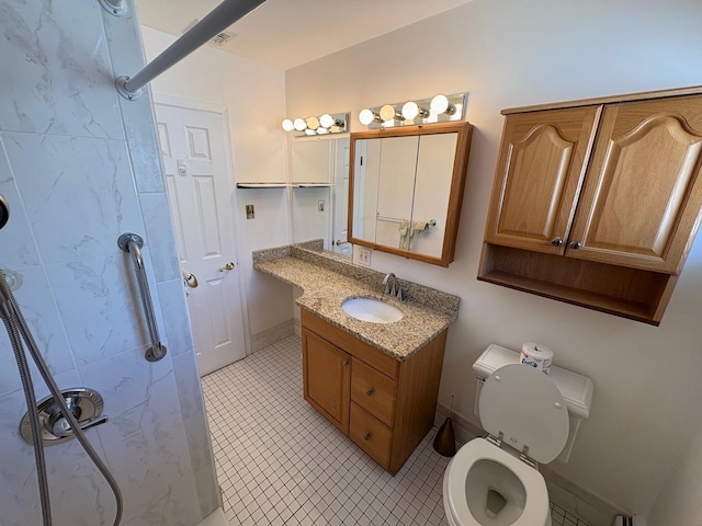 bathroom with vanity, toilet, and a shower