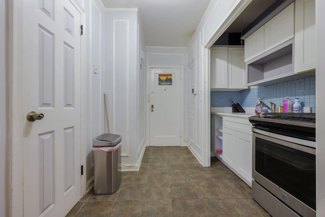 kitchen with white cabinets, decorative backsplash, and stainless steel electric range oven