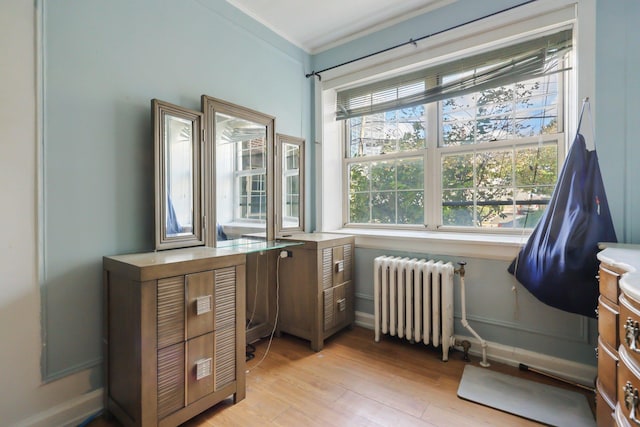 miscellaneous room with light wood-type flooring and radiator