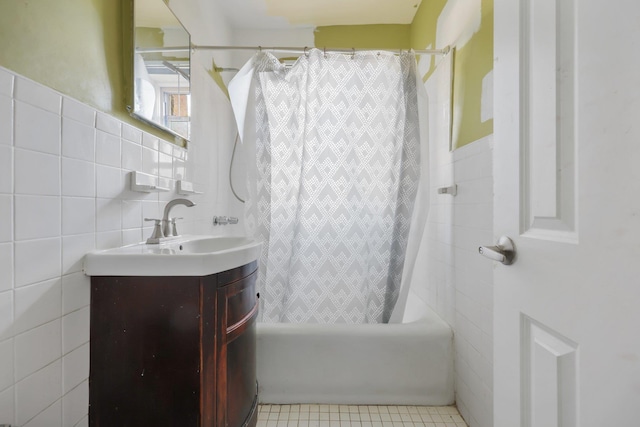 bathroom featuring tile patterned floors, vanity, tile walls, and shower / tub combo