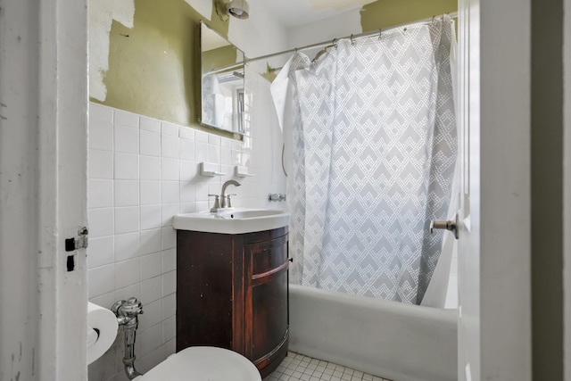 full bathroom with tile patterned flooring, vanity, toilet, and tile walls