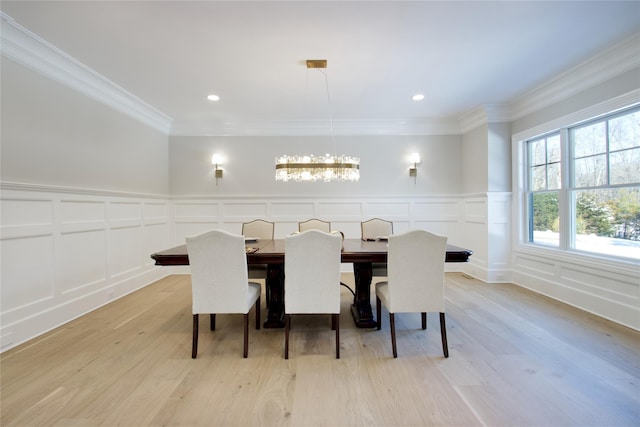 dining room featuring crown molding and light hardwood / wood-style floors