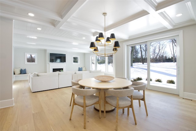 dining space featuring coffered ceiling, light wood-type flooring, ornamental molding, a notable chandelier, and beamed ceiling