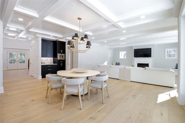 dining space with coffered ceiling, a notable chandelier, beamed ceiling, and light wood-type flooring