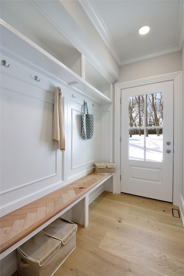 mudroom with ornamental molding and light wood-type flooring