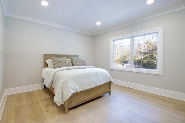 bedroom featuring crown molding and light wood-type flooring