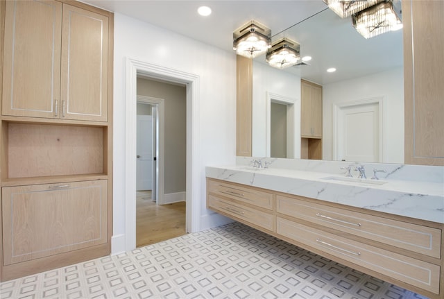 bathroom featuring an inviting chandelier and vanity