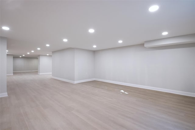 basement with light hardwood / wood-style floors