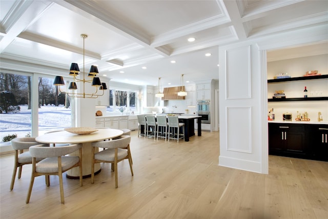 dining room with beamed ceiling, coffered ceiling, and light wood-type flooring