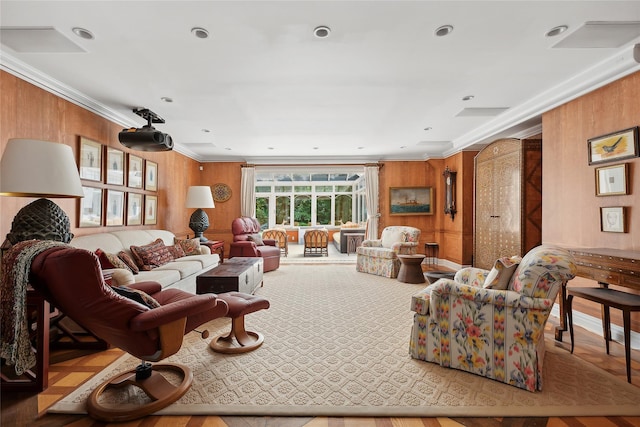 living room with ornamental molding and wooden walls