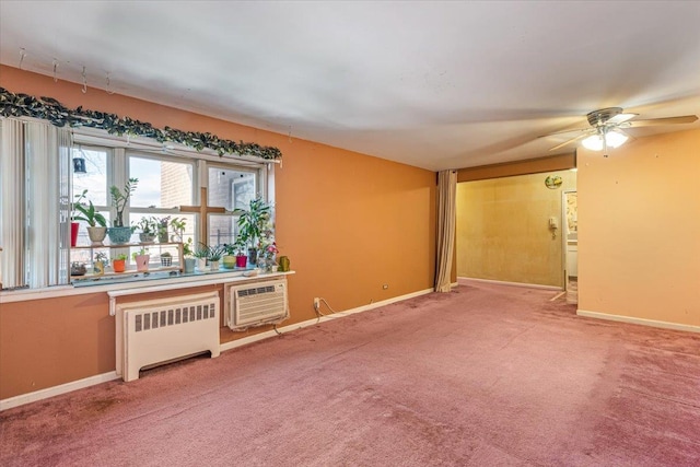 carpeted spare room featuring radiator, ceiling fan, and a wall mounted air conditioner