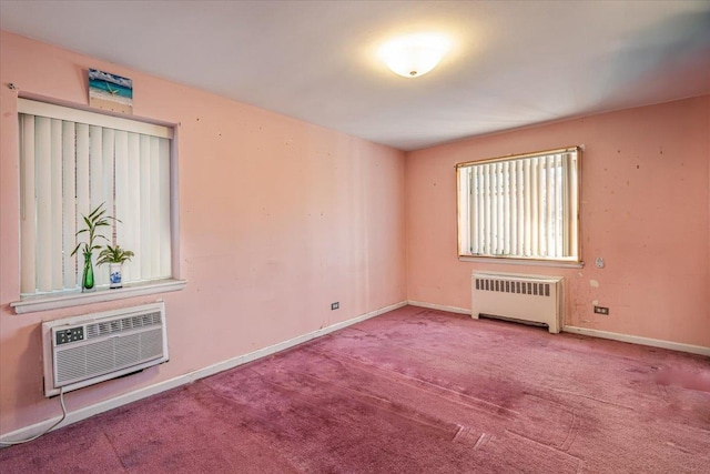 carpeted spare room featuring a wall mounted air conditioner and radiator