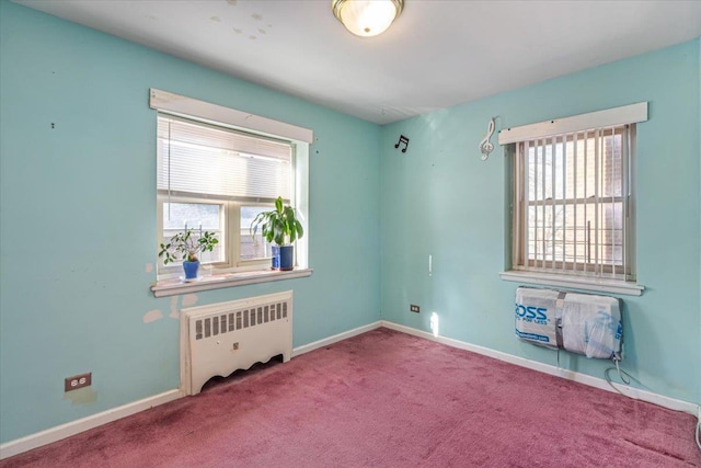 carpeted empty room featuring radiator