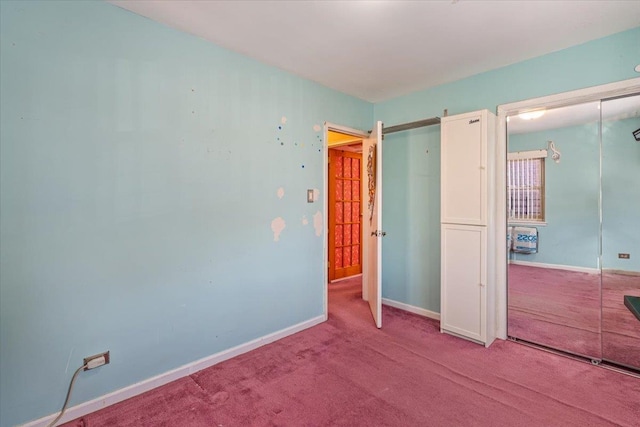 unfurnished bedroom with light carpet and a closet