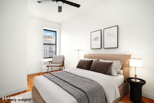 bedroom with light hardwood / wood-style floors and ceiling fan