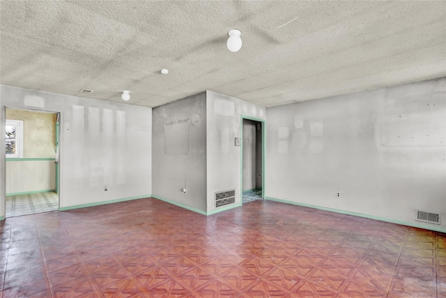 empty room featuring a textured ceiling