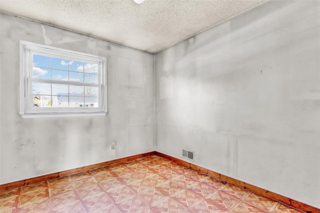 spare room with a textured ceiling