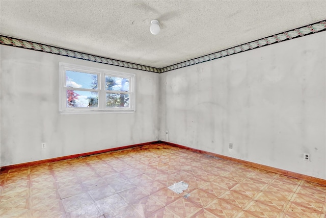 unfurnished room featuring a textured ceiling