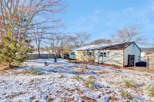 view of snow covered rear of property