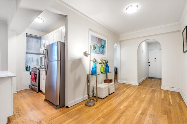 interior space featuring crown molding and light wood-type flooring