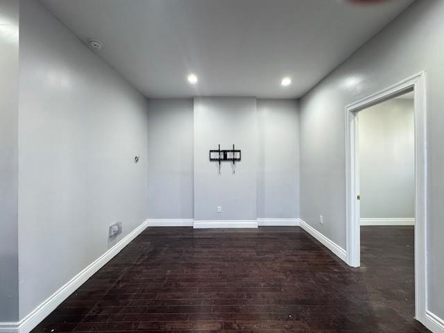 spare room featuring dark hardwood / wood-style floors