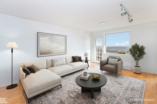 living room featuring track lighting and light hardwood / wood-style floors