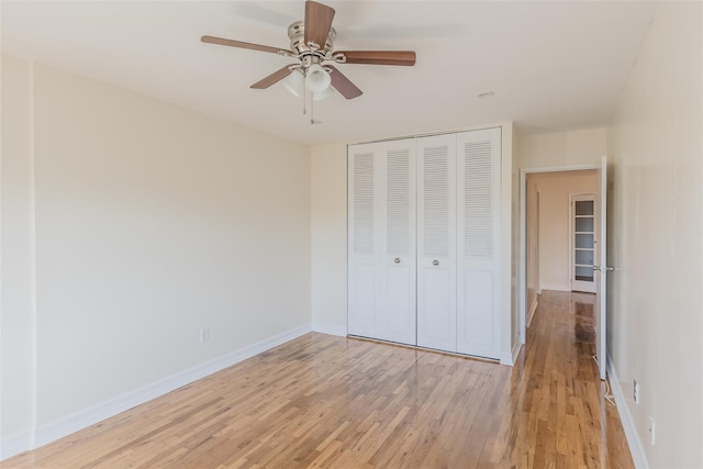 unfurnished bedroom with ceiling fan, a closet, and light hardwood / wood-style flooring